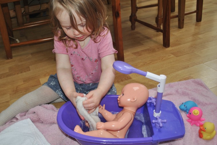 toddler role play activity to introduce baby care for a new sibling
